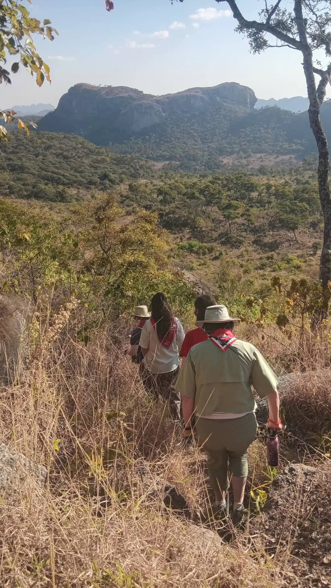Travellers hiking beneath granite peaks