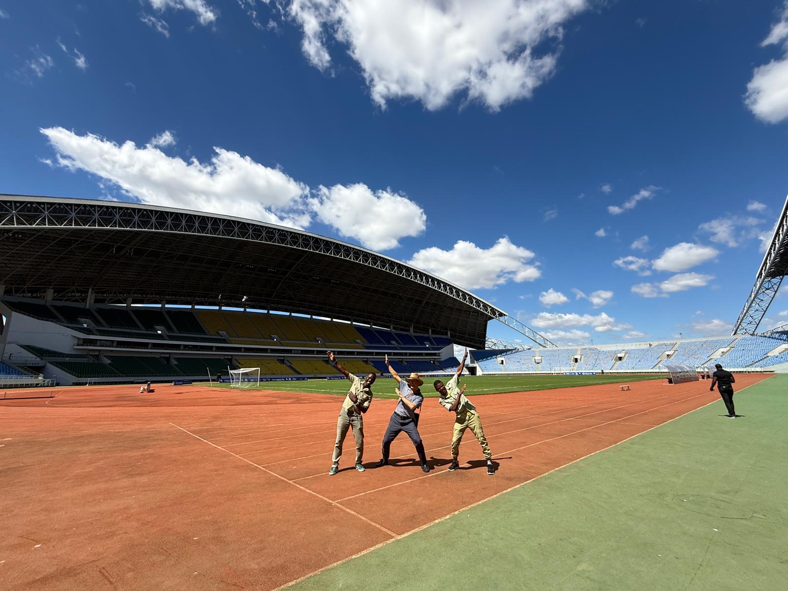 Guides and guest posing at Bingu National Stadium in Lilongwe